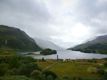 Scenic view of mountains against cloudy sky