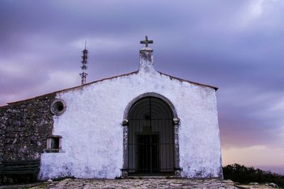 Low angle view of church against cloudy sky