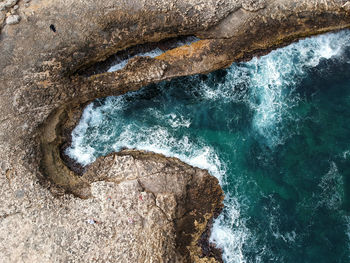 High angle view of rock formation in sea