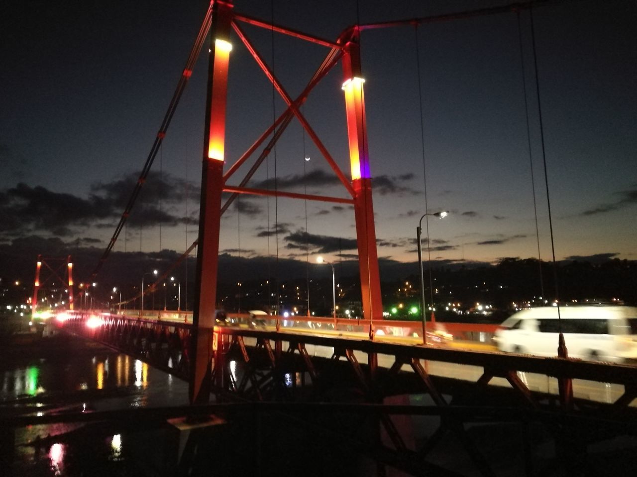 VIEW OF ILLUMINATED BRIDGE AT NIGHT