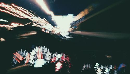 Low angle view of illuminated ferris wheel at night