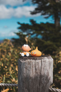 Close-up of toy on tree stump