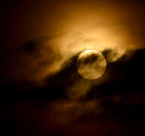 Low angle view of moon against cloudy sky