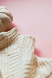 Close-up of woman with pink face against gray background