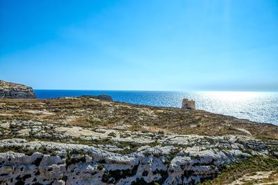 Scenic view of sea against blue sky