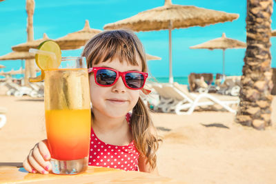 Close-up of drink on beach