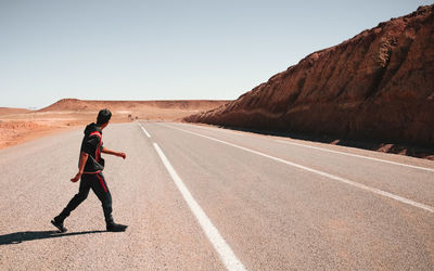 Full length of man on road against clear sky