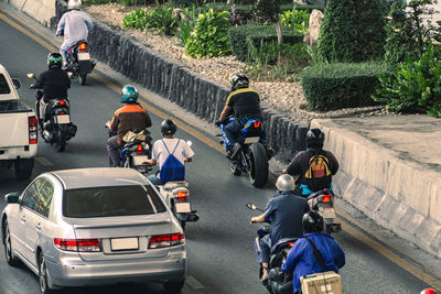 Rear view of people on road in city