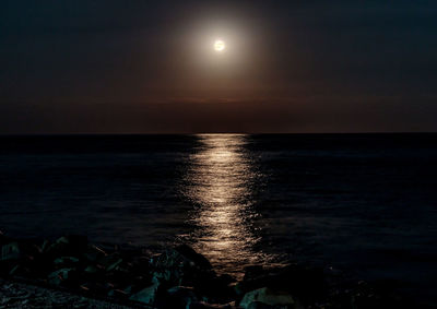 Scenic view of sea against sky at night