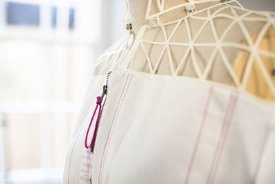 Close-up of clothes hanging on white fabric