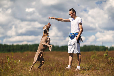 Full length of man standing on field against sky