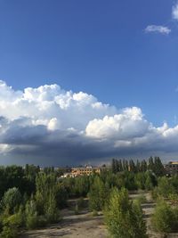 View of footpath against cloudy sky