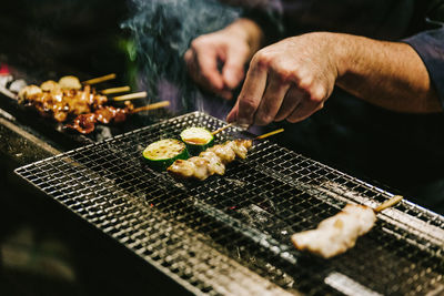 Man preparing food on barbecue grill