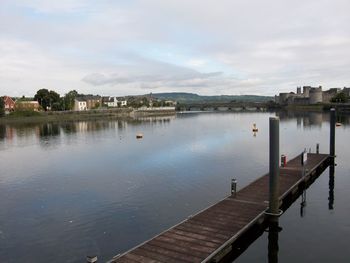 Scenic view of river against cloudy sky