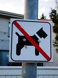 Close-up of road sign against sky
