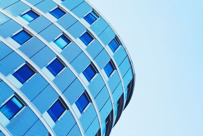 Low angle view of modern building against clear blue sky