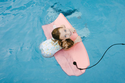 Girl playing with swimming float in water