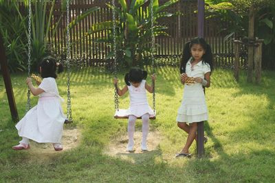 Full length of girl standing on field