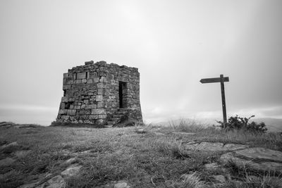 Old ruins on field against clear sky