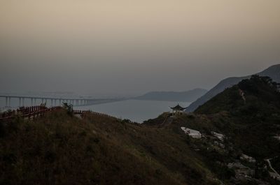 Scenic view of sea and mountains against sky