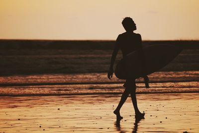 Full length of woman standing on beach