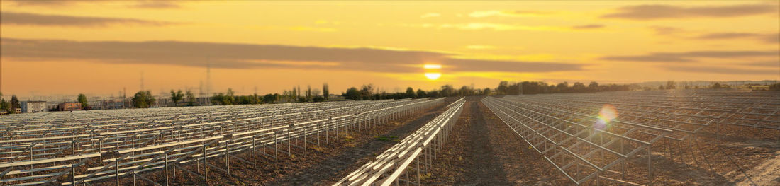 Railroad tracks against sky during sunset