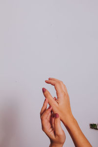 Close-up of woman hand over white background