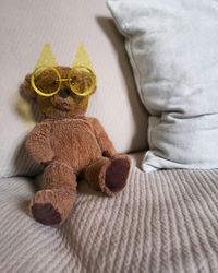 Close-up of baby boy sitting on sofa