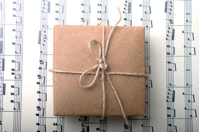 Close-up of wrapped box on sheet music