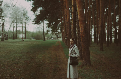 Rear view of woman walking in forest