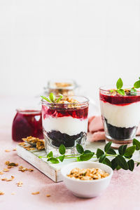 Cherry, cream cheese and chocolate biscuit portion layered dessert in glass. black forest trifle. 