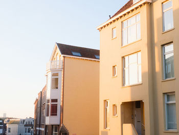 Low angle view of buildings in town against sky