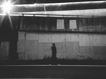 Silhouette man walking in corridor of building