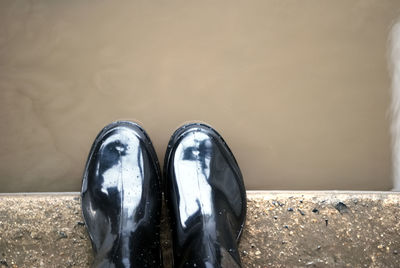 Directly above shot of shoes on retaining wall