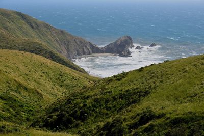 High angle view of sea and mountains against sky
