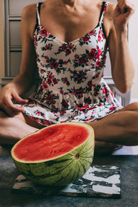 Midsection of woman with watermelon