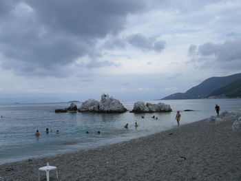 Scenic view of beach against cloudy sky