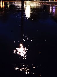 Reflection of illuminated sky on water at night