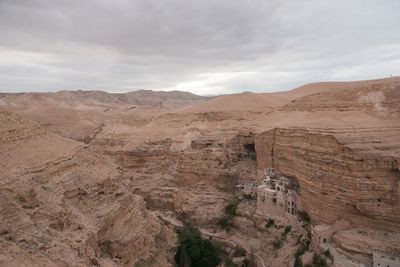 View of desert against cloudy sky