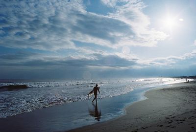 Man standing on beach against sky