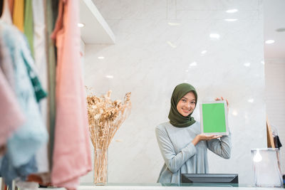 Portrait of young woman using mobile phone