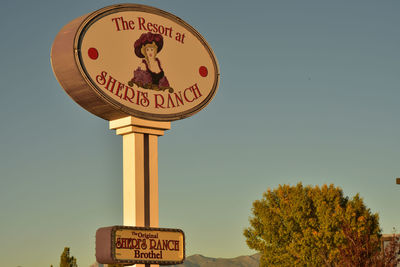 Close-up of road sign against clear sky