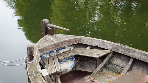 Wooden post on pier by lake