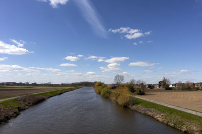 Road by river against sky