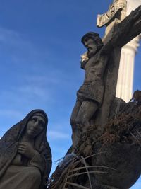 Low angle view of statue against sky