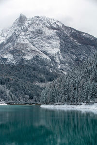 Scenic view of lake by mountain against sky