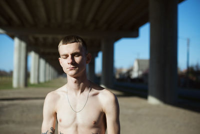 Portrait of young man standing in city