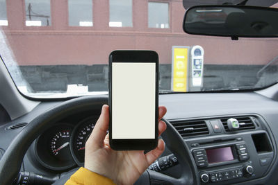 Man using smart phone in car