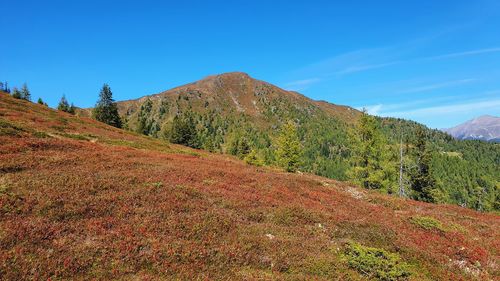 Scenic view of mountains against blue sky