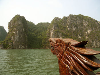 Rock formation in sea against sky